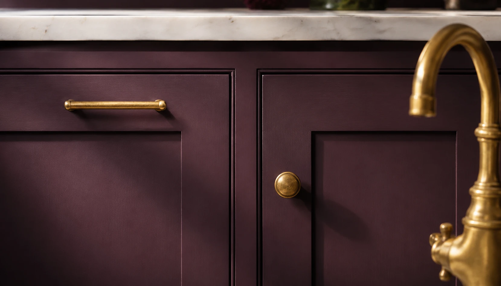 Deep plum kitchen cabinets with aged brass drawer pulls and brass faucet hardware