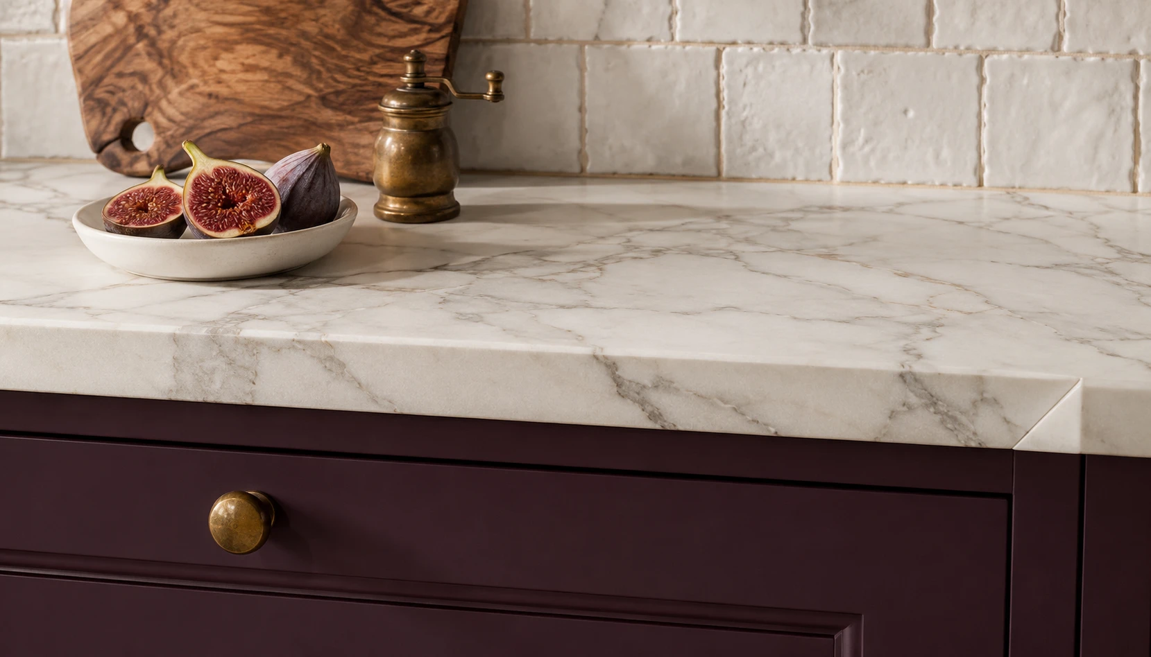 Deep plum kitchen cabinets with white Calacatta marble countertop showing perfect material pairing