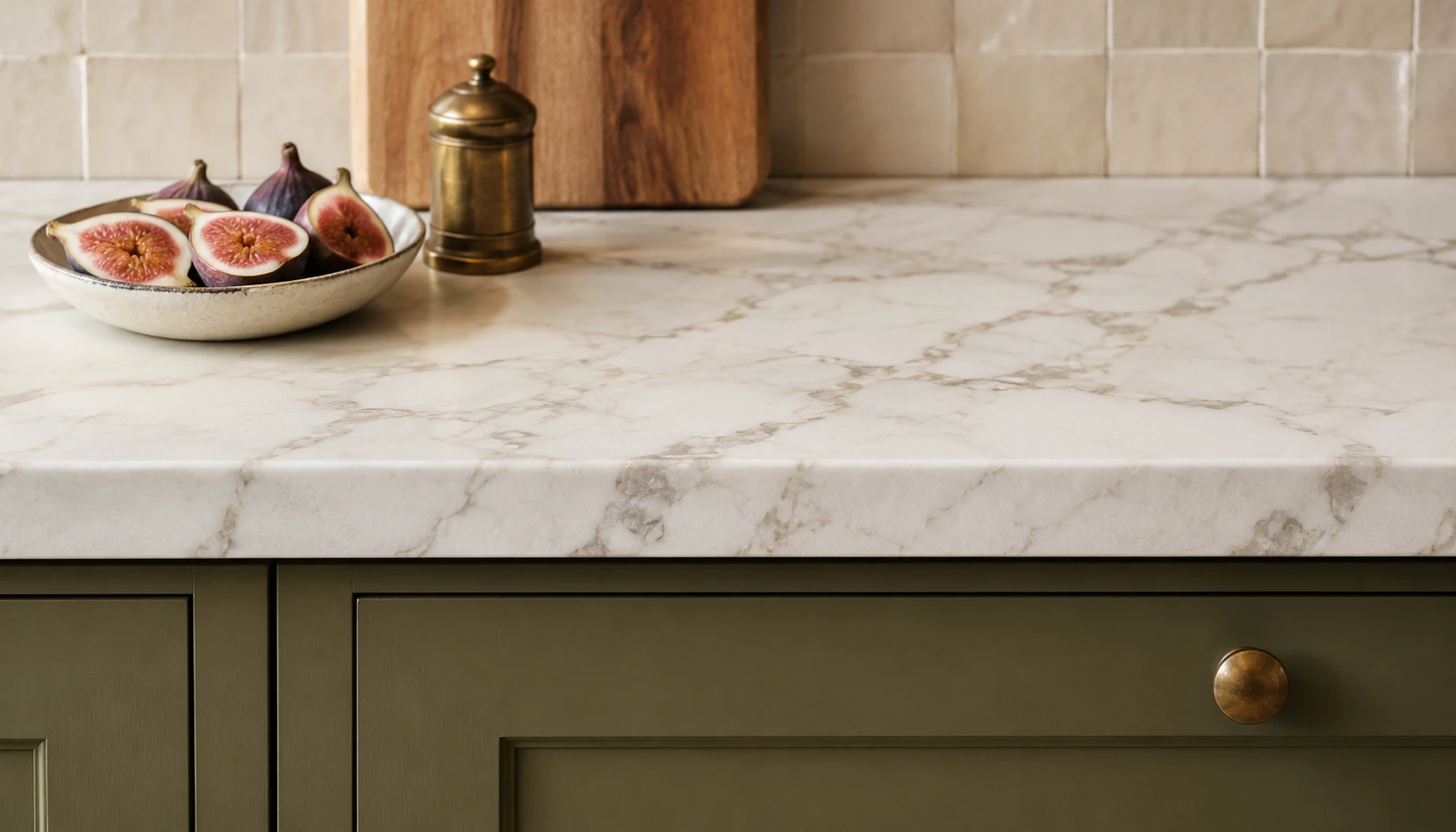Olive green kitchen cabinets with white Calacatta marble countertop showing perfect material pairing